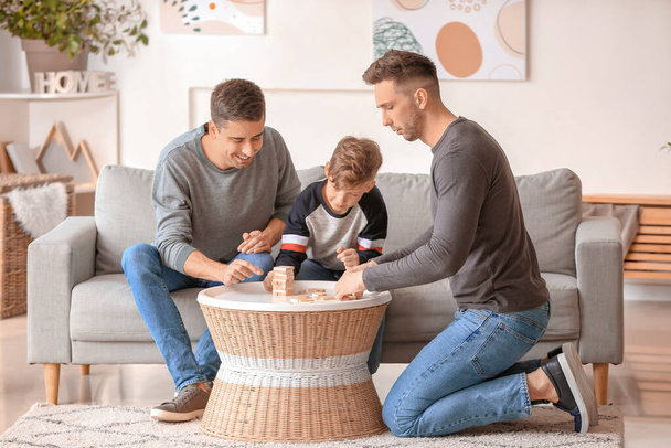 Happy gay couple with adopted child playing at home - Photo, Image
