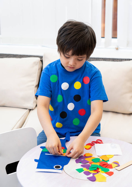Kid stay at home making colourful Koinobori (Carp streamers), Child boy doing Japanese fish kite on weekend, Ditance education or Home schooling, Children's Day (Japanese holiday) - 写真・画像