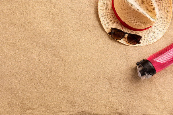 Summer fashion, summer outfit on sand background. Flat lay, top view - 写真・画像
