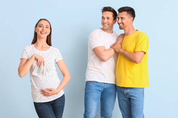 Gay couple and pregnant woman with money on color background - Photo, Image