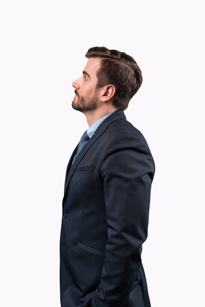Businessman standing looking away to future perspectives isolated on white background. - 写真・画像