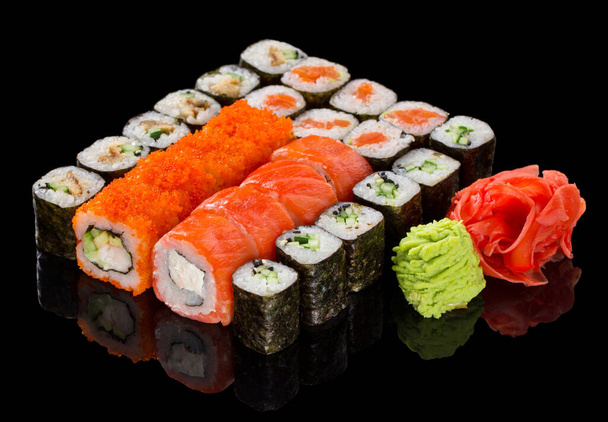 Assorted Sushi maki set with ginger and wasabi isolated on black background with reflection - Foto, Imagem