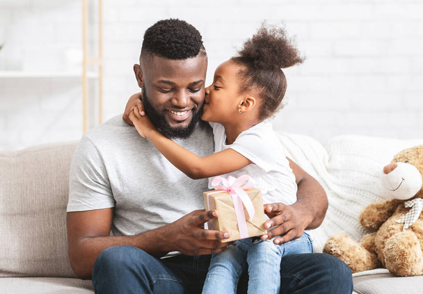 Beautiful preschool afro girl greeting her father at home - Foto, imagen