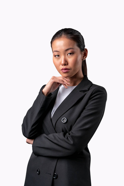Portrait of an attractive pensive asian businesswoman isolated on white background - Photo, image
