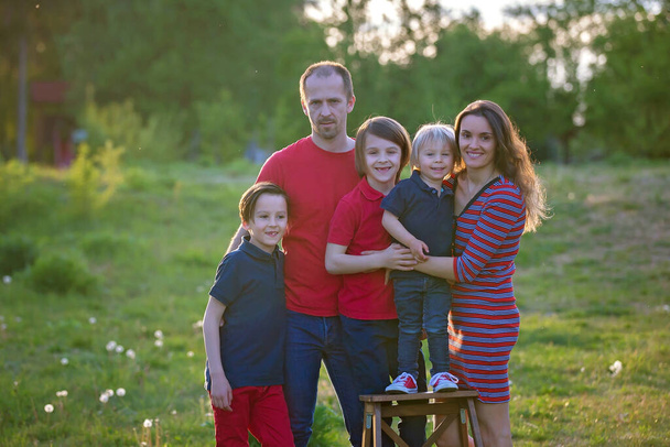 Spring portrait of happy family in nature on sunset, having fun together - Photo, Image