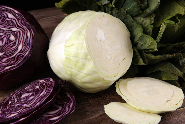 Three fresh organic cabbage heads. Antioxidant balanced diet eating with red cabbage, white cabbage and fresh savoy - Photo, Image