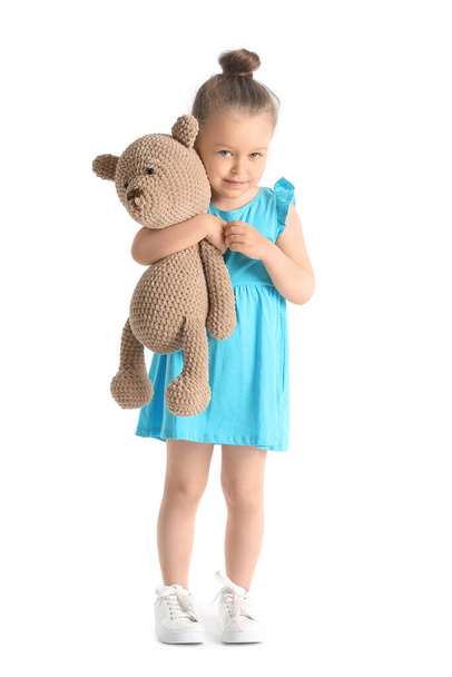 Klein meisje met speelgoed op witte achtergrond - Foto, afbeelding