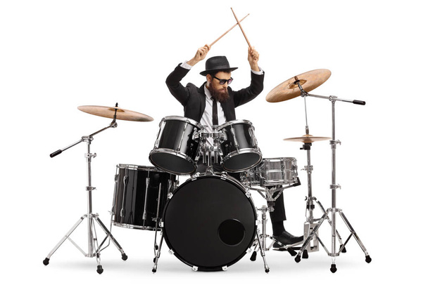 Drummer starting to play drums and holding drumsticks in the air isolated on white background - Fotó, kép