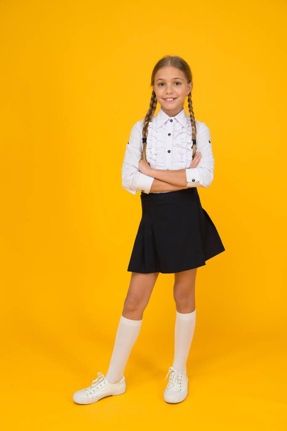 confident in knowledge. learning well bring future success. knowledge day. childhood development. girl in uniform. pretty little girl ready to study. back to school. education online while quarantine - Foto, afbeelding