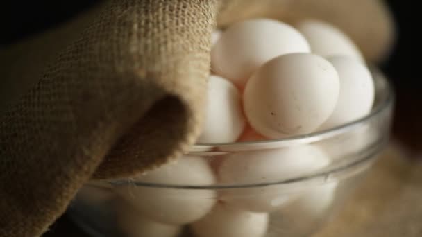 organic homemade fresh eggs in a glass bowl under burlap - Footage, Video