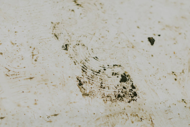 Black wet footprints over dirty tiles  - Photo, Image