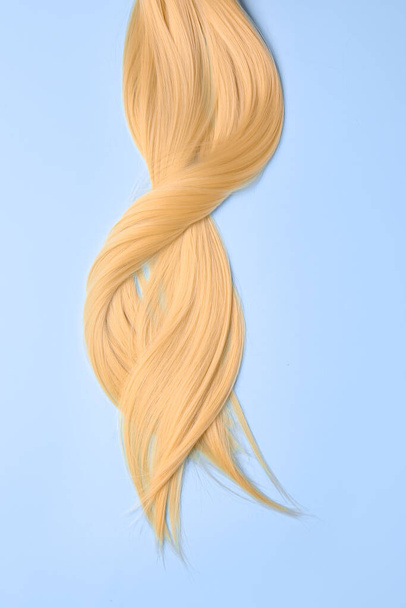 Beautiful long blonde hair on color background - Photo, Image