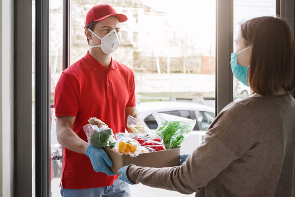 Stay home during quarantine. Courier delivers food from grocery store - Fotografie, Obrázek