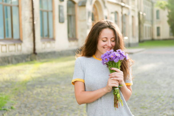Simple happiness. Summer pleasures. Make her happy. Flowers delivery. Fresh wildflowers. Flowers shop. Happy womens day. Girl smiling hold flowers bouquet. Greetings concept. Delight and satisfaction - Foto, Bild