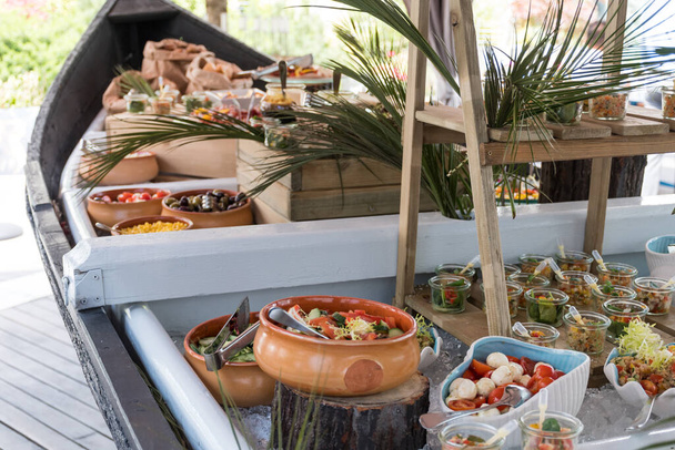 Luxury catering by the pool, food bloggers event, banquet, wedding, festive, hotel brunch buffet arrangement with clean simple design, decorations, boat filled with ice. Modern design and decorations - Fotó, kép