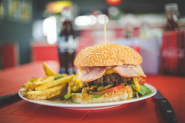 Close up image of a gourmet hamburger in a gourmet restaurant - 写真・画像