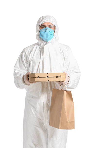 Courier of food delivery service in protective suit on white background. Concept of epidemic - Foto, imagen