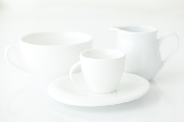 white cup with saucer and milk jug - Valokuva, kuva