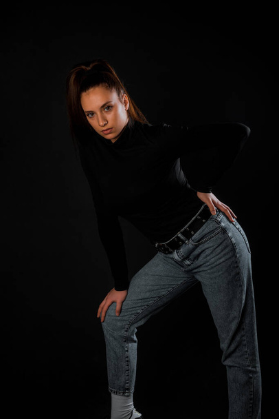 Studio body shot of a fashion female model posing in modern clothing - Фото, изображение