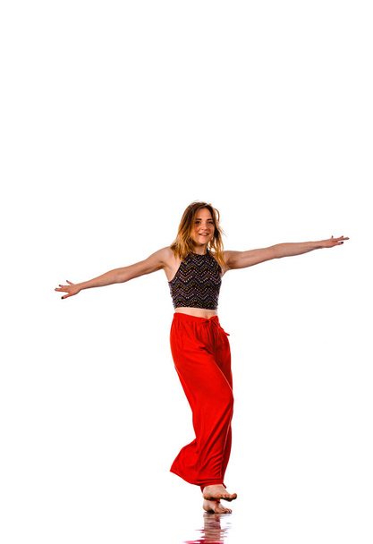 Young beautiful athletic woman dancing modern dance hip-hop on white background - Photo, image