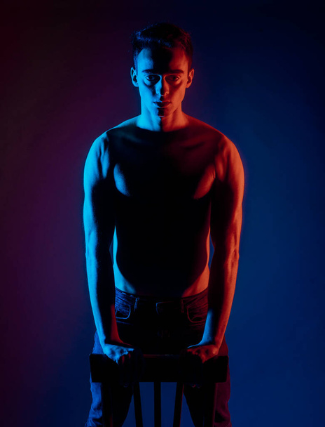 Torso shot of a cool shirtless guy wearing trendy black jeans - Фото, изображение