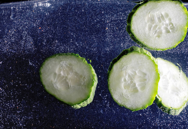 Water drops on ripe cucumber. Fresh vegetables background with copy space for your text. Vegan and vegetarian concept. - Fotó, kép