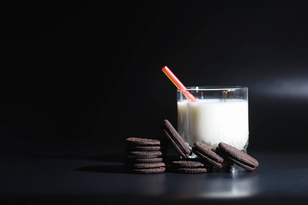 Milk drink in glass. Farm milk and cookies. Delicious snack with cow's milk and fresh pastries. - Photo, image