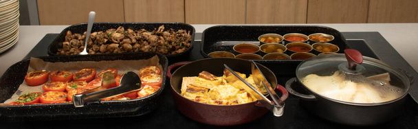 Selection of self service catering continental breakfast buffet display, catering or brunch table food buffet filled with all sorts of delicious food, meat platters in a hotel or restaurant setting - Foto, Bild