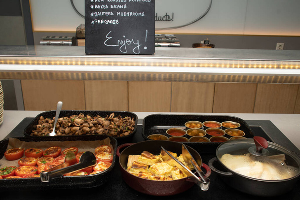 Selection of self service catering continental breakfast buffet display, catering or brunch table food buffet filled with all sorts of delicious food, meat platters in a hotel or restaurant setting - Foto, immagini