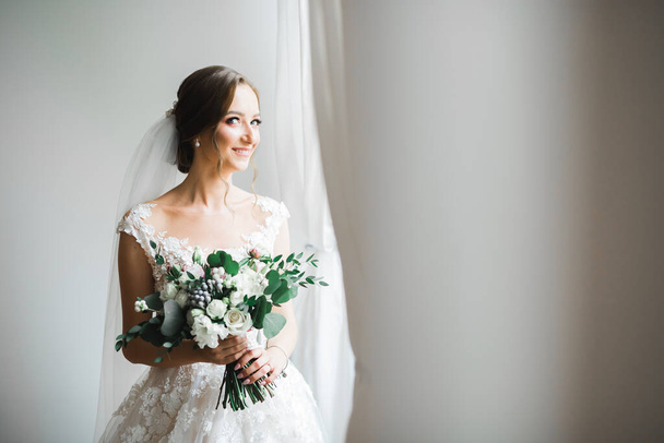 Bride holding big and beautiful wedding bouquet with flowers - Fotó, kép