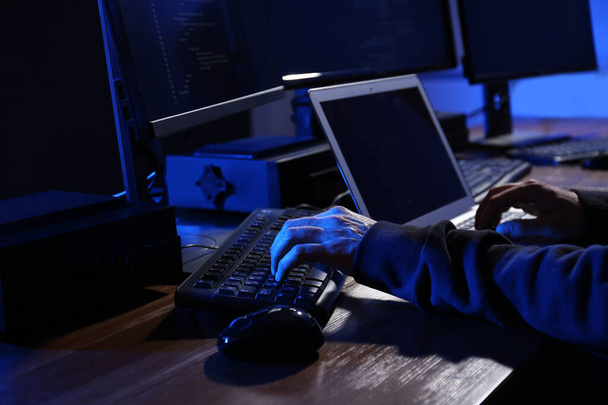Hacker with computers in dark room, closeup. Cyber crime - Fotoğraf, Görsel