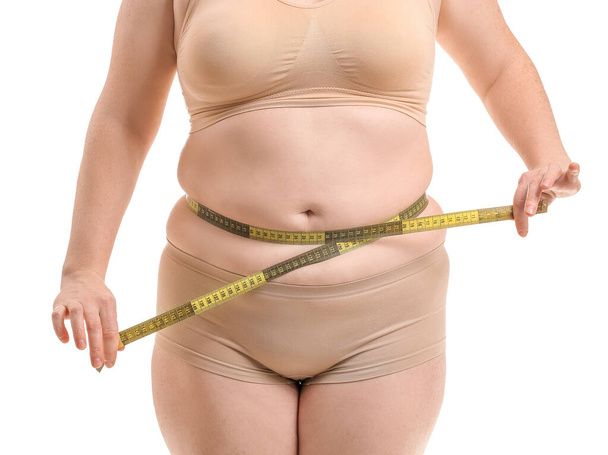 Overweight woman with measuring tape on white background, closeup. Weight loss concept - Foto, Imagen