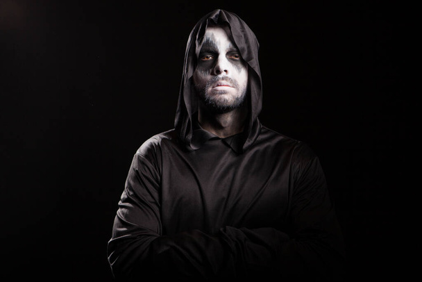 Thoughtful grim reaper over black background - Photo, Image