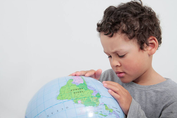 little boy with globe on white background stock photo  - Фото, зображення