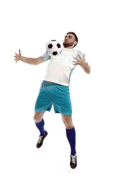 Young man playing football on white background - Foto, Imagem