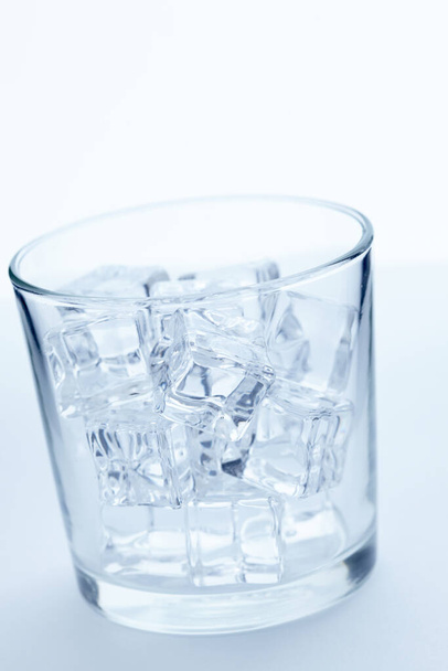 glass with ice cubes, close view  - 写真・画像