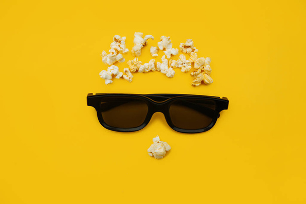 Abstract image of viewer, 3D glasses and popcorn on yellow background. Concept cinema and entertainment - Фото, изображение