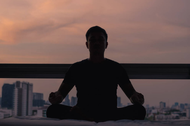 Mindful saudável maduro asiático homem praticando meditação em casa sentado na cama para o equilíbrio mental relaxante sobre o estresse e desfrutar de tempo longe da tecnologia
. - Foto, Imagem