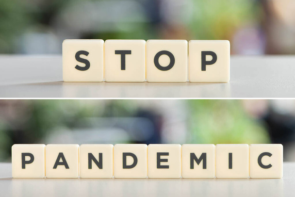white cubes with stop pandemic lettering on white desk, covid-19 concept - Photo, Image
