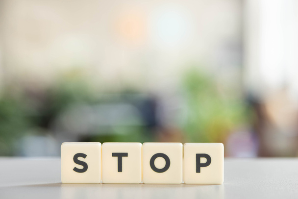white cubes with stop lettering on white desk - 写真・画像