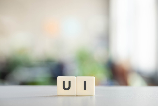 white cubes with ui lettering on office desk  - Photo, Image