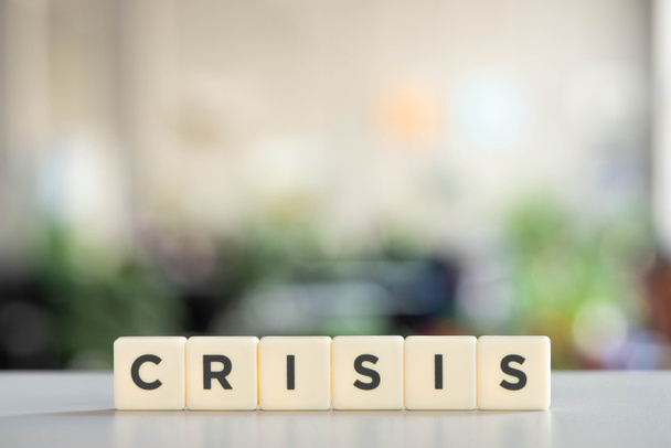 white cubes with world crisis on white desk in office - Foto, Imagem
