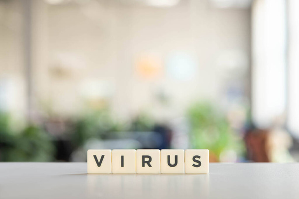 white cubes with virus lettering on white desk, covid-19 concept - Photo, Image