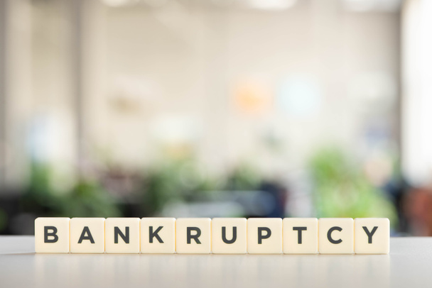 white blocks with bankruptcy word on office desk - Фото, зображення