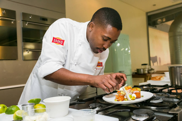 Johannesburg, South Africa - November 10, 2016: Young African Chef demonstrating various techniques at cooking class - 写真・画像