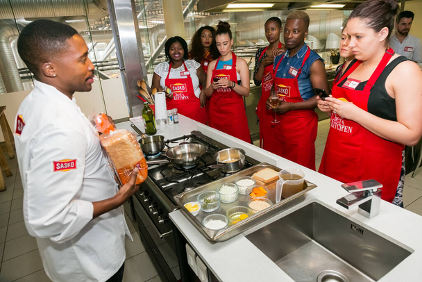 Johannesburg, South Africa - November 10, 2016: Diverse young people learning to cook and bake at a cooking class - 写真・画像