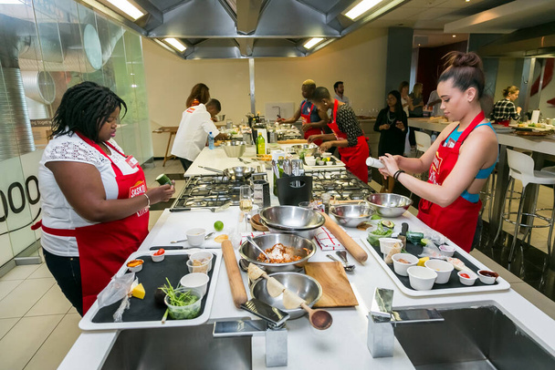 Johannesburg, South Africa - November 10, 2016: Young African women learning to cook and bake at a cooking class - Fotó, kép