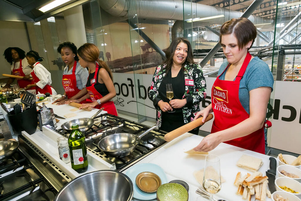 Johannesburg, South Africa - November 10, 2016: Diverse young women learning to cook and bake at a cooking class - Fotó, kép