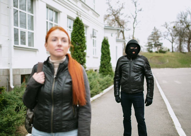 Young woman gets bag snatching on the street , Beware of  thief, robbery on the young red hair girl on the street - Photo, Image