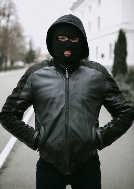 portrait of man thief in mask on the street - Photo, Image